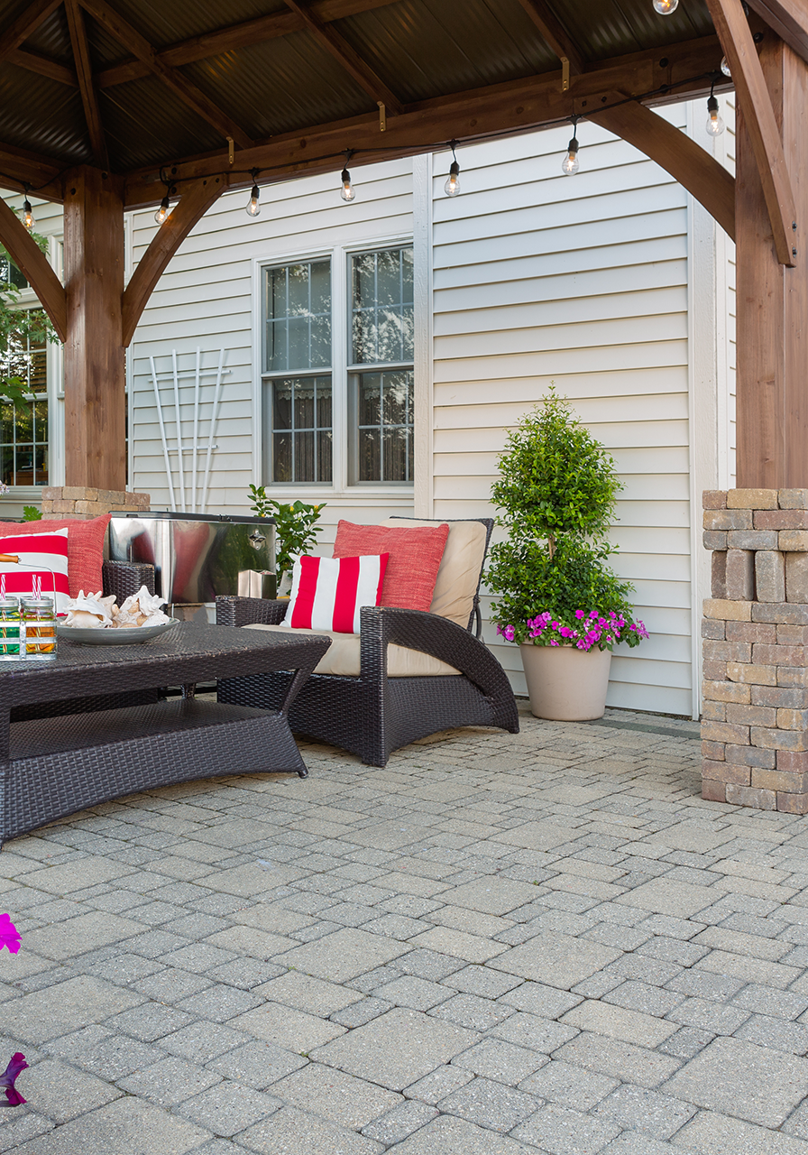 Santa Monica paver patio with wood pergola and stone pillars