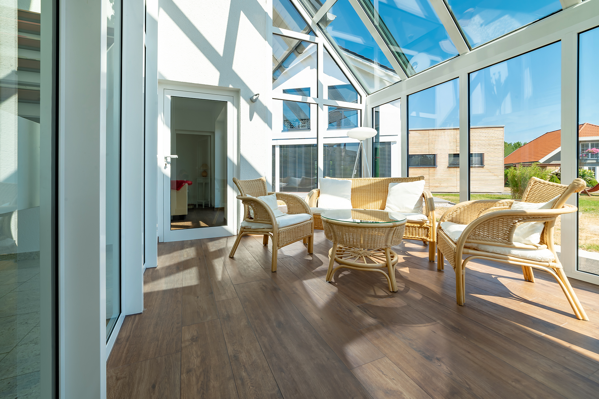 Pergola with lattice roof providing dappled shade over patio seating